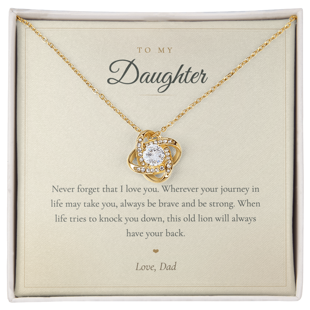 Hand holding the This Old Lion Has Your Back message card with love knot necklace