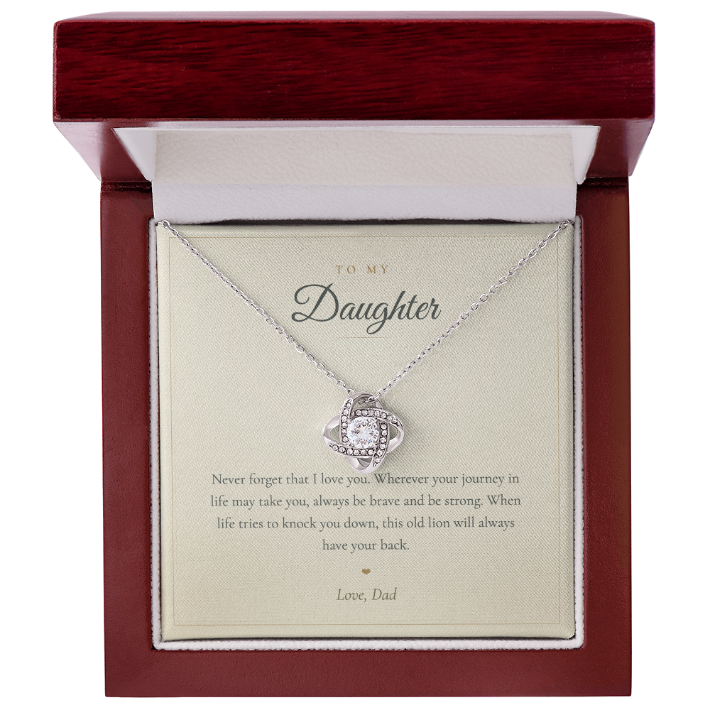 Close up of a hand holding the daughter love knot necklace and keepsake card