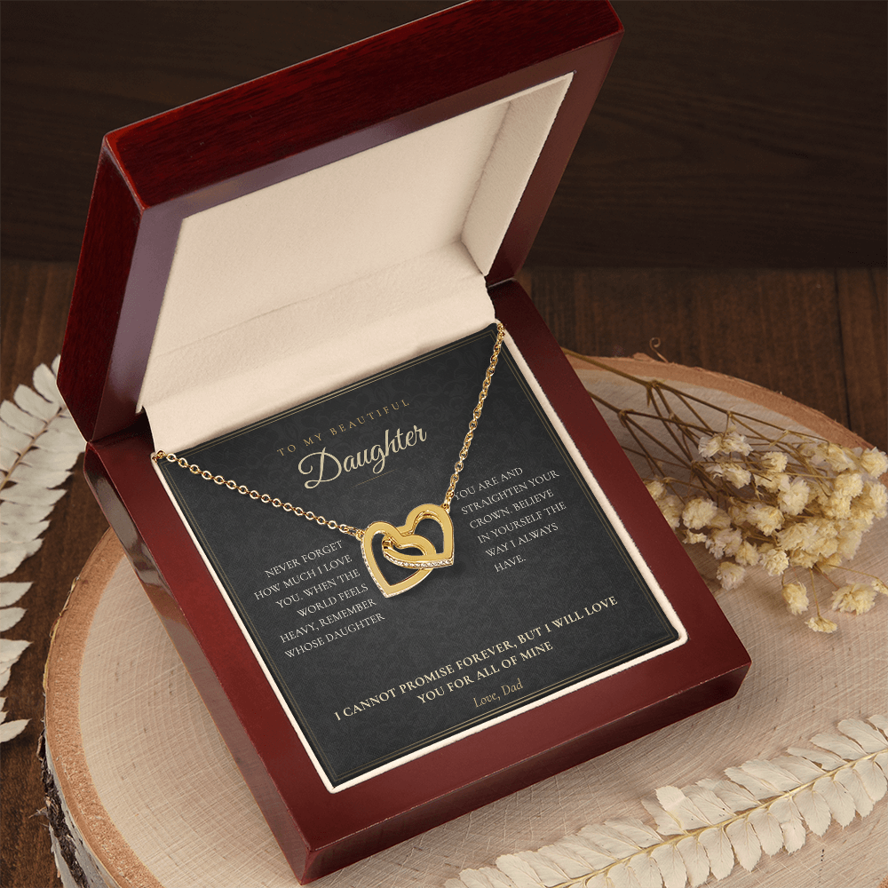Daughter from Dad message card and hearts necklace in a white gift box on a wooden table